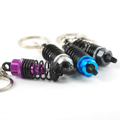 Adjustable Shock Absorber Coilover Keychains in purple, silver, blue and dark grey