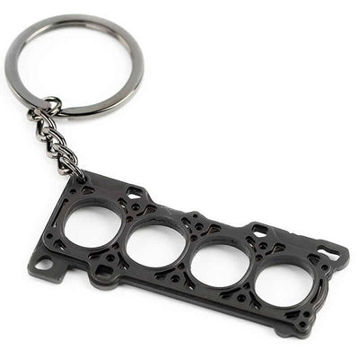 JDM 4 cylinder head gasket keychain on white background, perfect gift for car enthusiasts, mechanics, or anyone who loves modified cars and engines