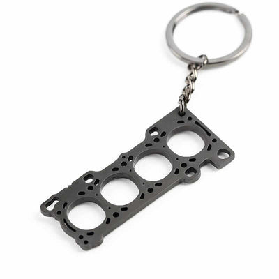 JDM 4 cylinder head gasket keychain on white background, perfect gift for car enthusiasts, mechanics, or anyone who loves modified cars and engines