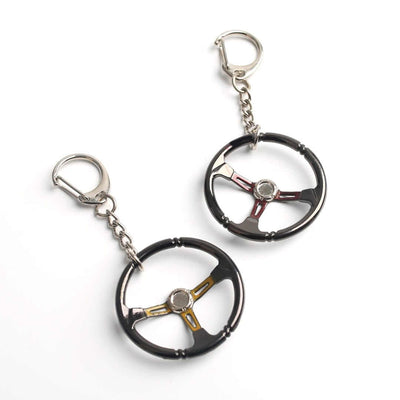 Red and Yellow chrome racing steering wheel keychains on white background